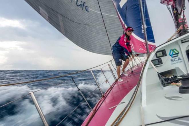 Onboard Team SCA – Justine Mettraux takes advantage of a lull in the wind to adjust theh J2 clew - Leg six to Newport – Volvo Ocean Race 2015 © Corinna Halloran / Team SCA